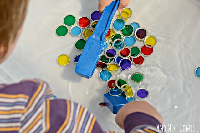 Child playing with magnets in a water sensory bin