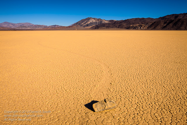 a photo of a rock making a curved path at the racetrack in death valley