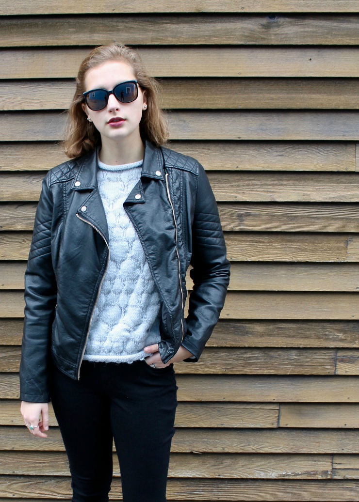 leather jacket, hand knit sweater, black skinny jeans and white trainers