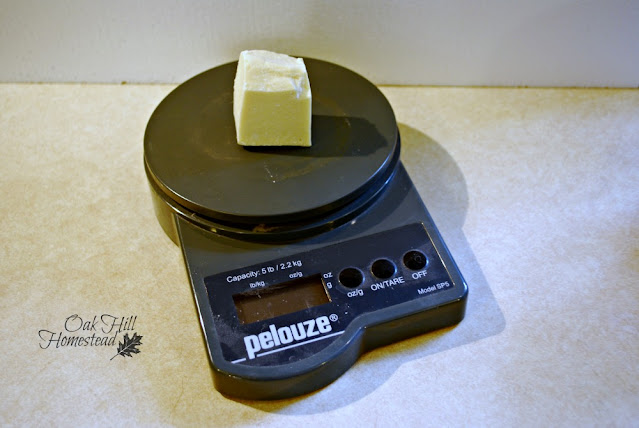 Weighing a chunk of cocoa butter on a postal scale.