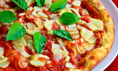 Image of pizza with garlic cloves and basil