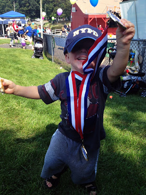 toddler with medals