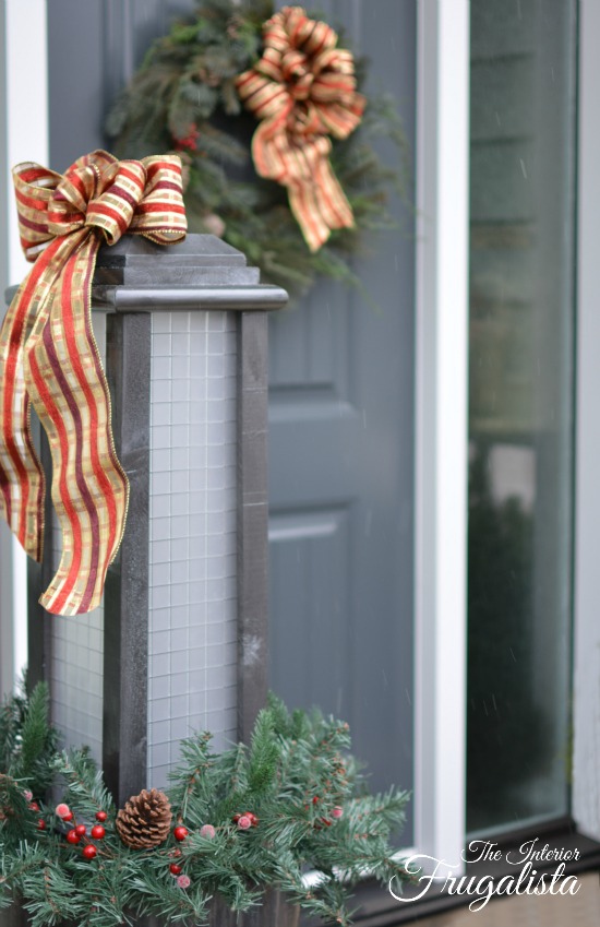Light the front porch this Christmas with these large budget-friendly DIY outdoor scrap wood holiday lanterns conveniently on set and forget timers.