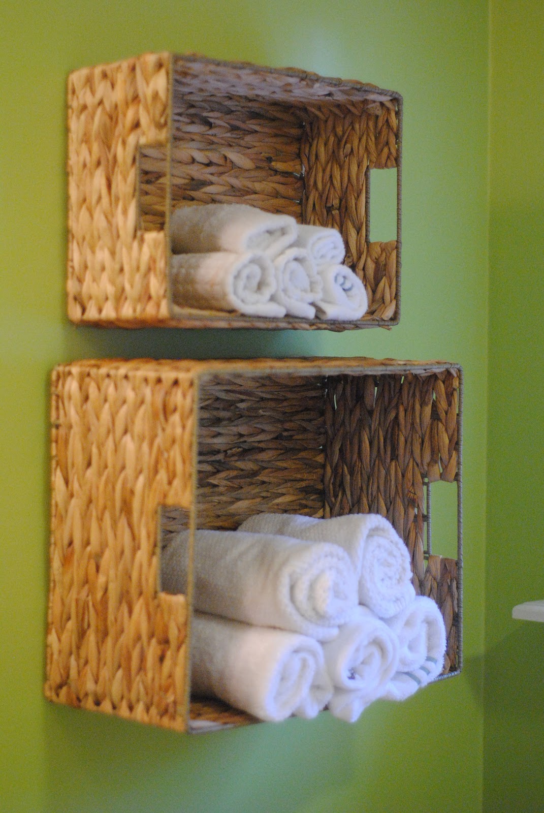 Baskets behind toilet  Bathroom towel storage, Baskets on wall