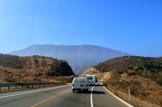 Road with rolling hills and mountains.