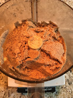 Processed almond flour beginning to clump. https://trimazing.com/ Photo of 4 cups of raw almonds processed into flour and starting to clump. Shown after spatula scraped down sides of processor bowl. https://trimazing.com/