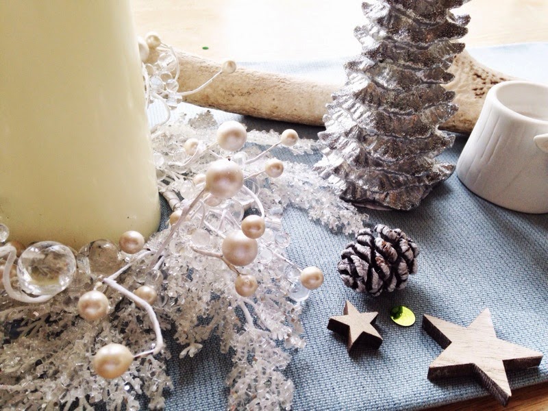 Christmas table decoration with candles and pinecones