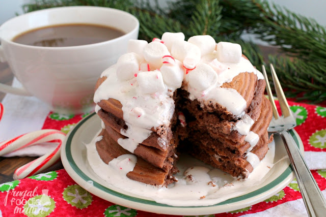 Light & fluffy pancakes are infused with lots of hot cocoa & peppermint flavor, and then topped with a super simple marshmallow cream topping in these Peppermint Hot Cocoa Pancakes.