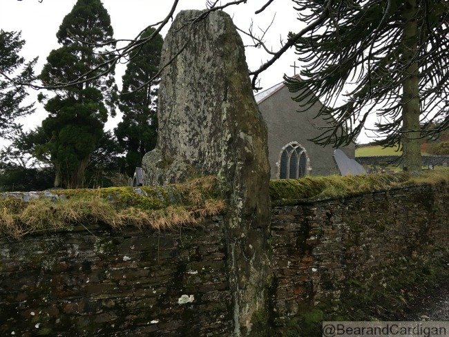 very tall standing stone in old wall