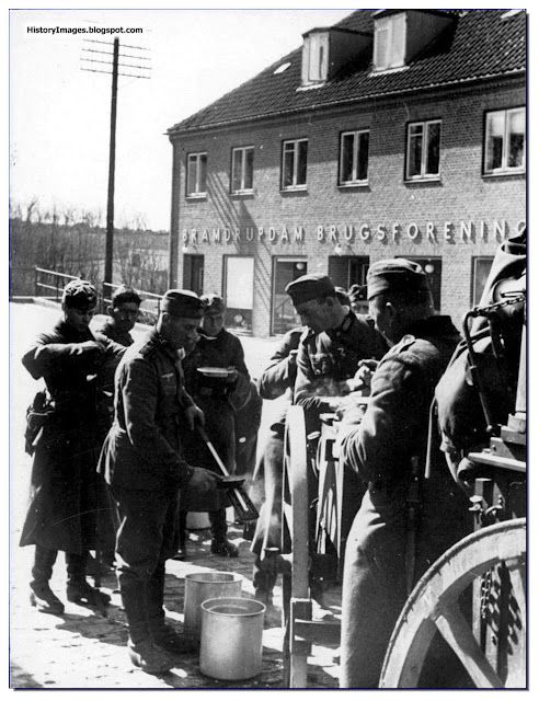 1940 German soldiers having soup street Danish village