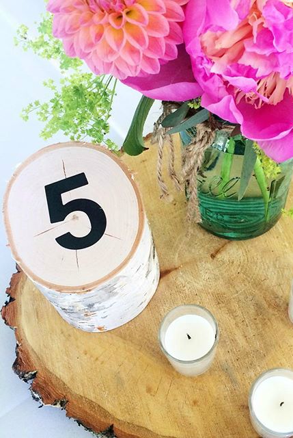 great idea for wedding table numbers- piece of wood (birch) cut at an angle + vinyl number sticker! could paint the number on too!