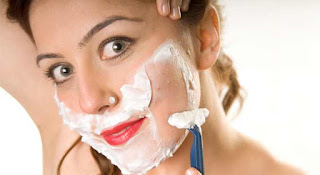 girl shaving face with razor