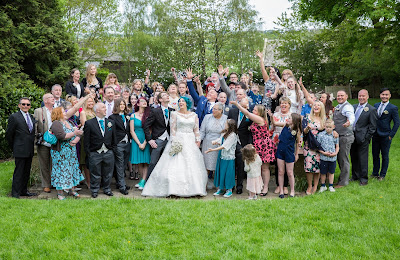 group shot of bride groom and family celebrating