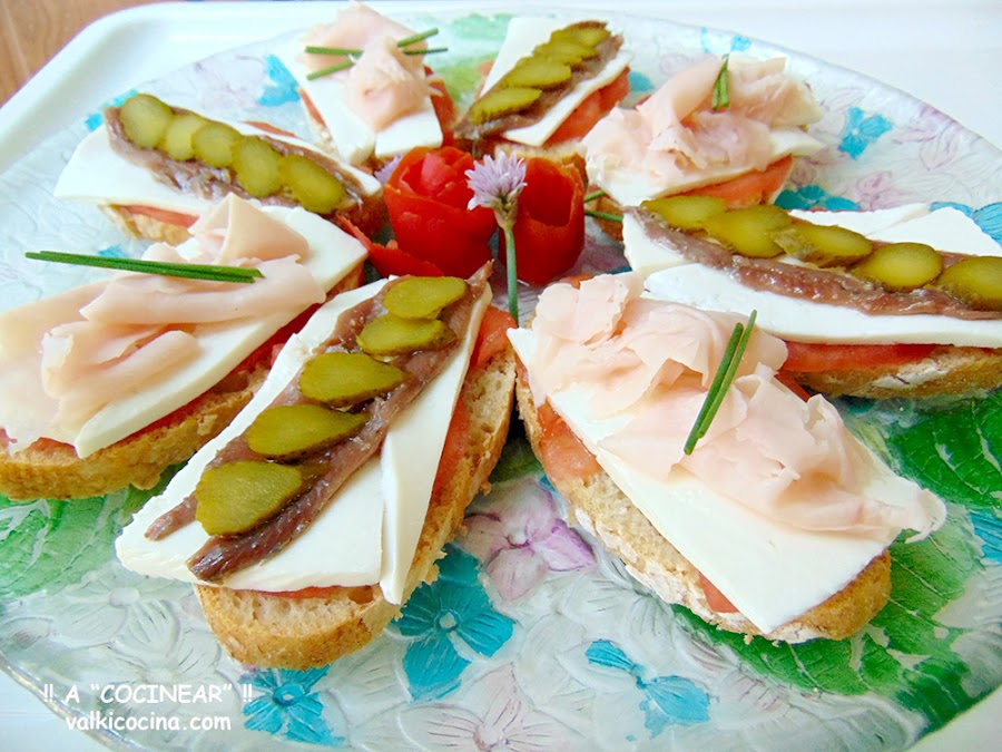 Montaditos o tostas de queso fresco con anchoas y pavo