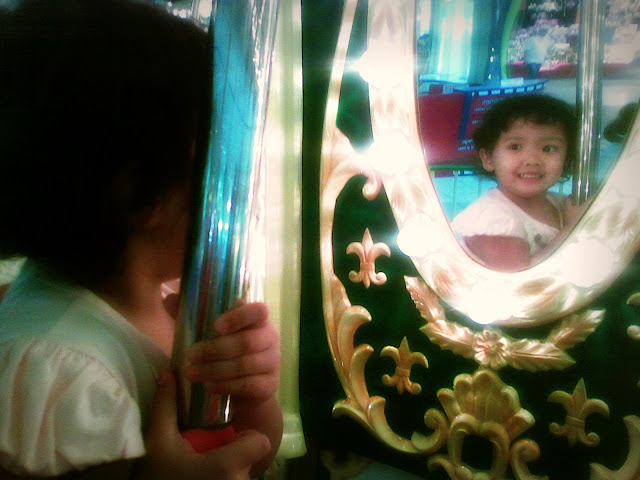 Mirror image of Kecil on the carousel