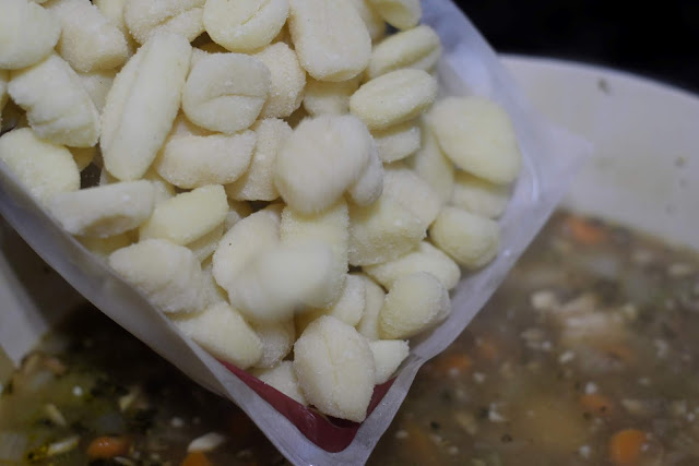 The gnocchi being added to the soup.  