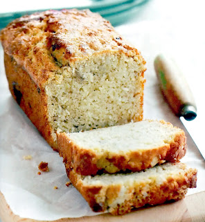 Classic banana-based loaf containing coconut in the batter served sliced for tea time