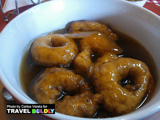 Picarones are Peruvian donuts made by deep frying a combination of sweet potato, squash, flour, yeast, sugar and anise. Photo by Carlos Varela for TravelBoldly.com