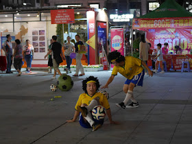 two young men wearing wigs doing a soccer show in Zhongshan