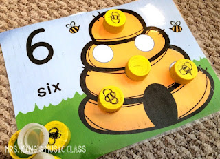 Princesses Don’t Do Math – Number Mat Ideas for a Reluctant Learner.  You’ll love these number mat ideas for getting your reluctant preschooler playing, counting and adding their way to success.  Number mats are great for developing number sense and these mats work with bottle caps!  They can work with playdough, rocks, and more but I think you’ll like how perfectly the bottle caps can work with any theme.  Great for preschool and kindergarten aged students in workstations or at home.