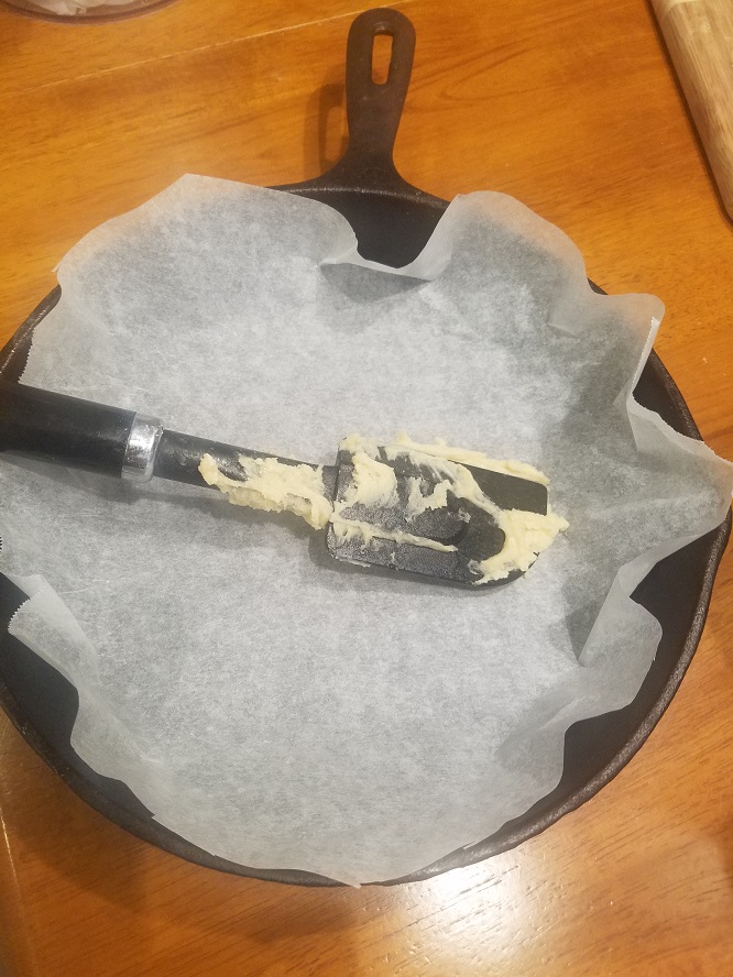 this is a parchment paper lined cast iron skillet use to make a shortcake recipe in