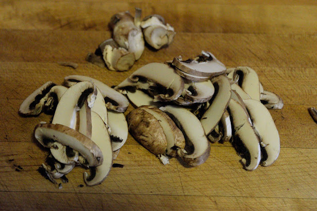 Sliced mushrooms on a cutting board. 