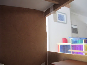 Inside front view of a dry fit of a dolls' house shed kit, with a central wall installed.