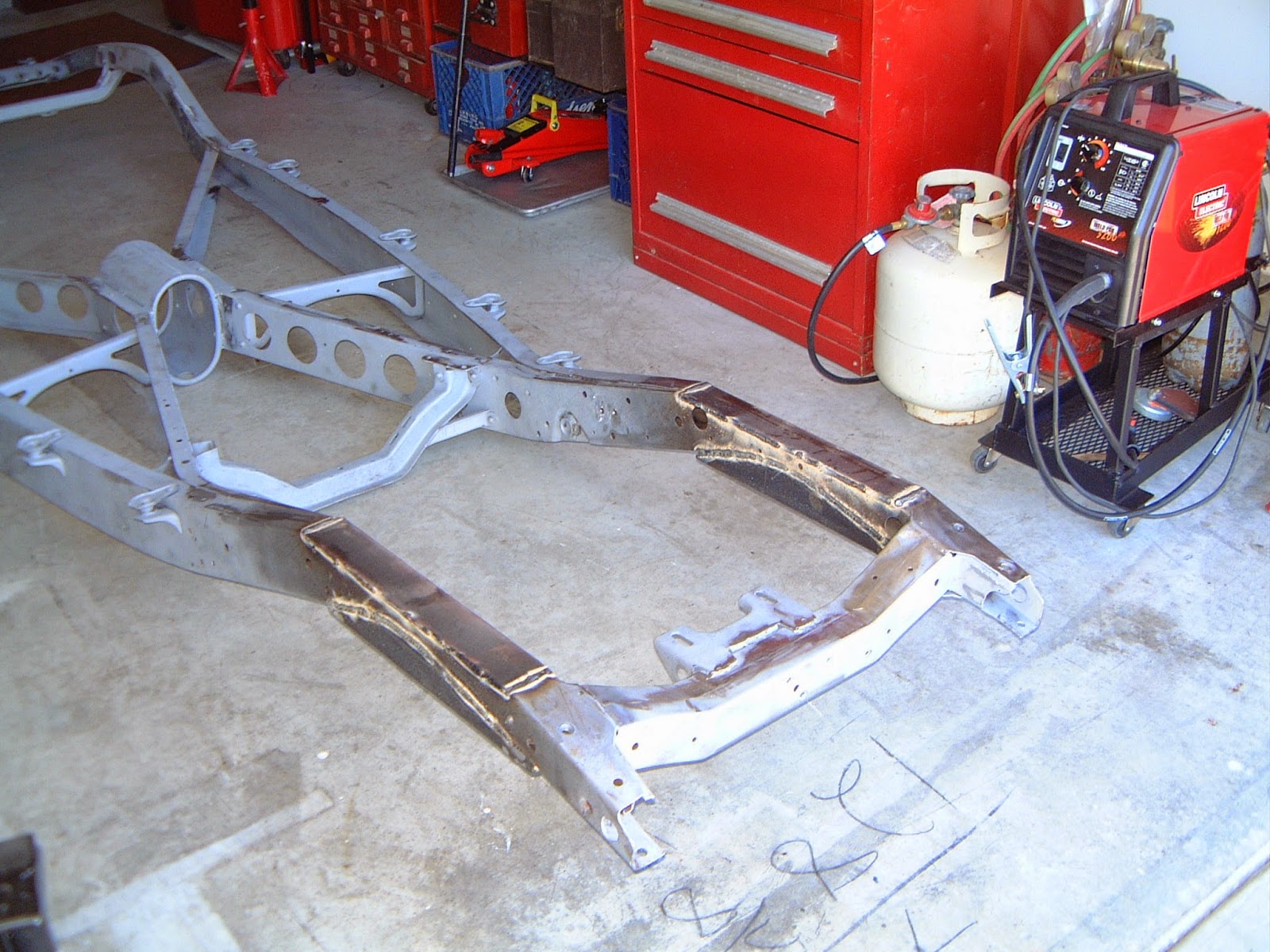 1937 Plymouth Preparing chassis for front suspension kit installation.