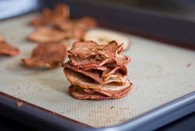 baked apple chips on a baking mat 