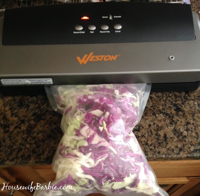 An American Housewife Shredding and Vacuum Sealing Fresh Cabbage with