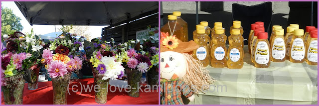Table full of flowers in vases and lots of honey for sale