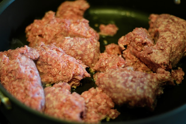 Ground beef being browned in a skillet. 