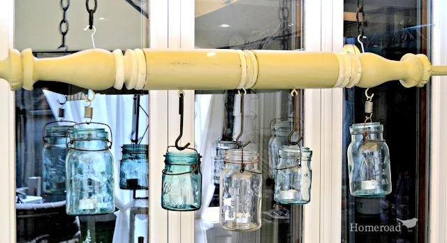 large green turned post with hanging mason jars