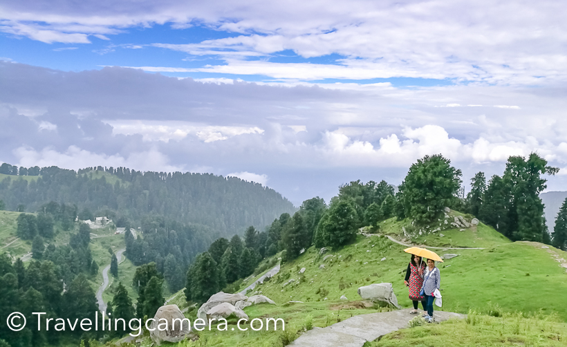 During my recent visit to Dalhousie, we planned to do a small trek to Dainkund (Temple Pohlani). This Photo Journey shares about our experience through clouds and how we beaten the rain. And if you are in Dalhousie during Monsoon, this trek is highly recommended. You literally walks through clouds and it's an easy trek.We drove through Kala Top to the base of this trek, which is entry gate of Air force base. We parked our car there and started the trek. There is well paved path for 1 km, which is maintained by temple authority. This path certainly made our lives easy during monsoons.This is a view after walking up for 250 meters. This road goes down to Dalhousie and Kala Top.As we started the trek, rain started and we thought of skipping it and going to Khajjiar instead. But in few minutes we encouraged each other to use umbrellas and start climbing up. And at the end it proved to be rewarding.Clouds were playing hide and seek with us. At times, they were chasing us and in few minutes sun was shining by clearing them away.Throughout the trek you are exposed to some breathtaking views of valley full of high deodars and birds flying all around. We saw few colorful butterflies on our way but couldn't click them well.We did the trek at our own pace. Stopped many times and enjoyed quick snacks which we were carrying with us. And Urvi was always ready to pose :)On the way, there is a temple which is 2.5 kilometers away from road. Lot of local folks visit this temple. Interesting most of the temples in this region don't have roofs. There is a little shop near the temple from where you can buy snacks and juices.While walking through the mountains, Vibha pointed towards this cloud form. With a smile she says - 'doesn't it look like a giraffe?'. Do you think so?There is a beautiful view through clouds. Most of the times clouds stopped our view of surroundings but such views through clouds were very special.This is 3 kilometers trek which means you need to walk for 6 kilometers. And we had 3 years old trekker with us. Mentioning that to share that anyone can do this trek. It's very easy and the experience can be very rewarding. On a clear day, Khajjiar is visible from top.Panoramic views from top were mesmerizing.There is small shelter on the way. We took a break here where it started raining heavily.Every now and then we were stopping to views awesome scenes all around us. Here Urvi is trying to locate Khajjiar :)Not sure what Indu is trying to do on phone because there is no signal on these hills :) . Probably checking the photograph she just clicked with her phone.We reached there quite early and met this gentleman. He offers horse riding to tourists coming to this place.Urvi loved walking throughout and showing some interesting views to us. Vibha and Urvi were most observant from the lot.It was time to head back and don't miss to watch time-lapse videos shared below.