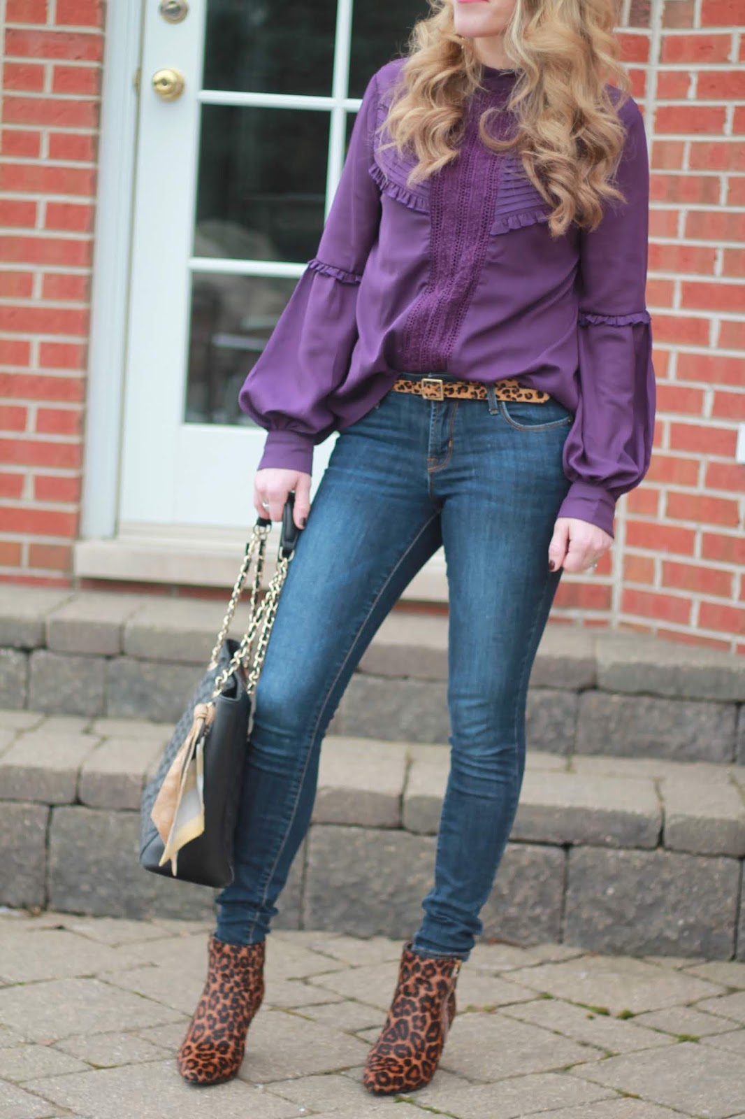 purple ruffle blouse, Rockstar jeans, leopard booties, leopard belt, black quilted leather tote