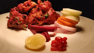 Chicken  serve with lemon onions pomegranate seeds beetroot for Kandhari chicken  recipe