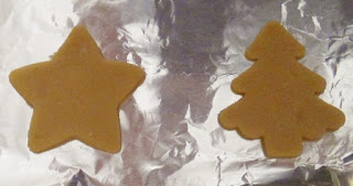 Sugar cookie dough shaped by Christmas cookie cutters