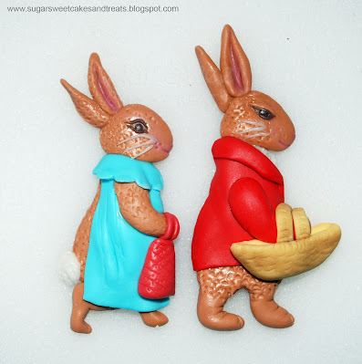 Closeup of hand sculpted, gumpaste Flopsy and Benjamin Bunny.