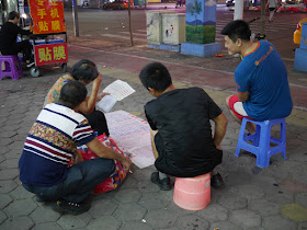woman figuring out fortunes in Zhongshan, China