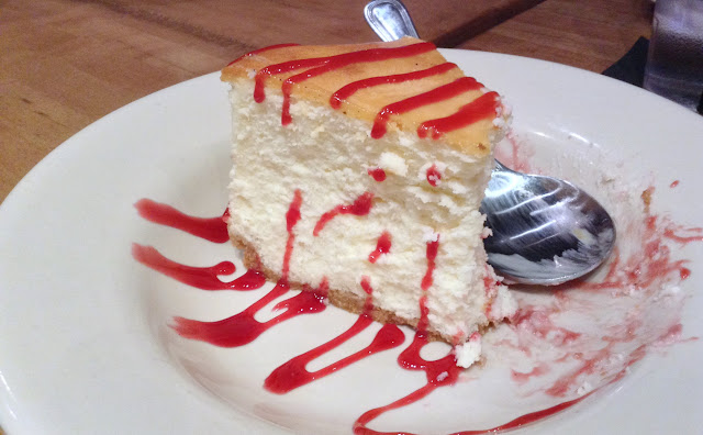 Homemade cheesecake with raspberry drizzle at @TheRailBurger