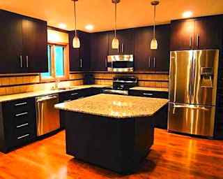 Modern feng shui kitchen with dark color cabinetry.