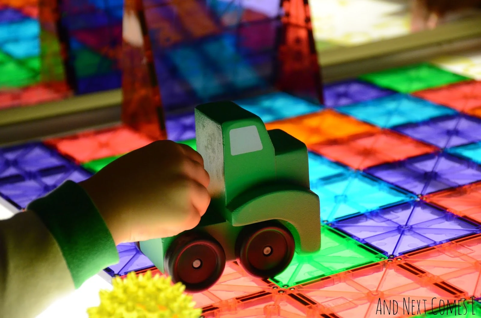Truck driving on a soccer field made of Magna-Tiles from And Next Comes L