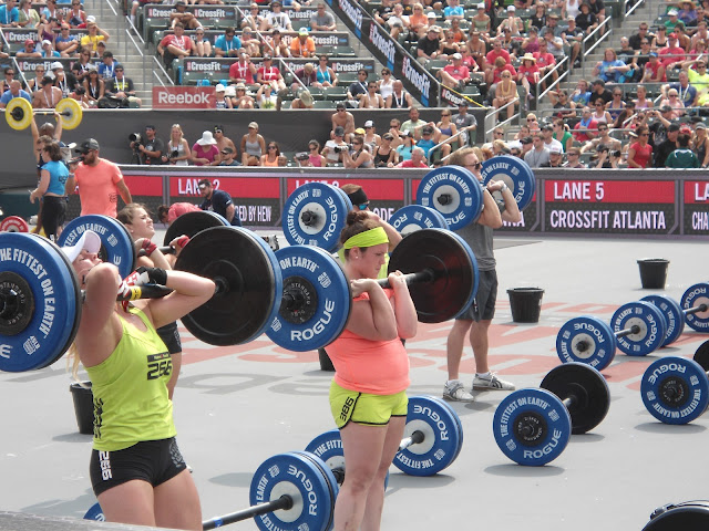 view of female competitors holding olympic barbells on their shoulders during the 2012 CrossFit Games