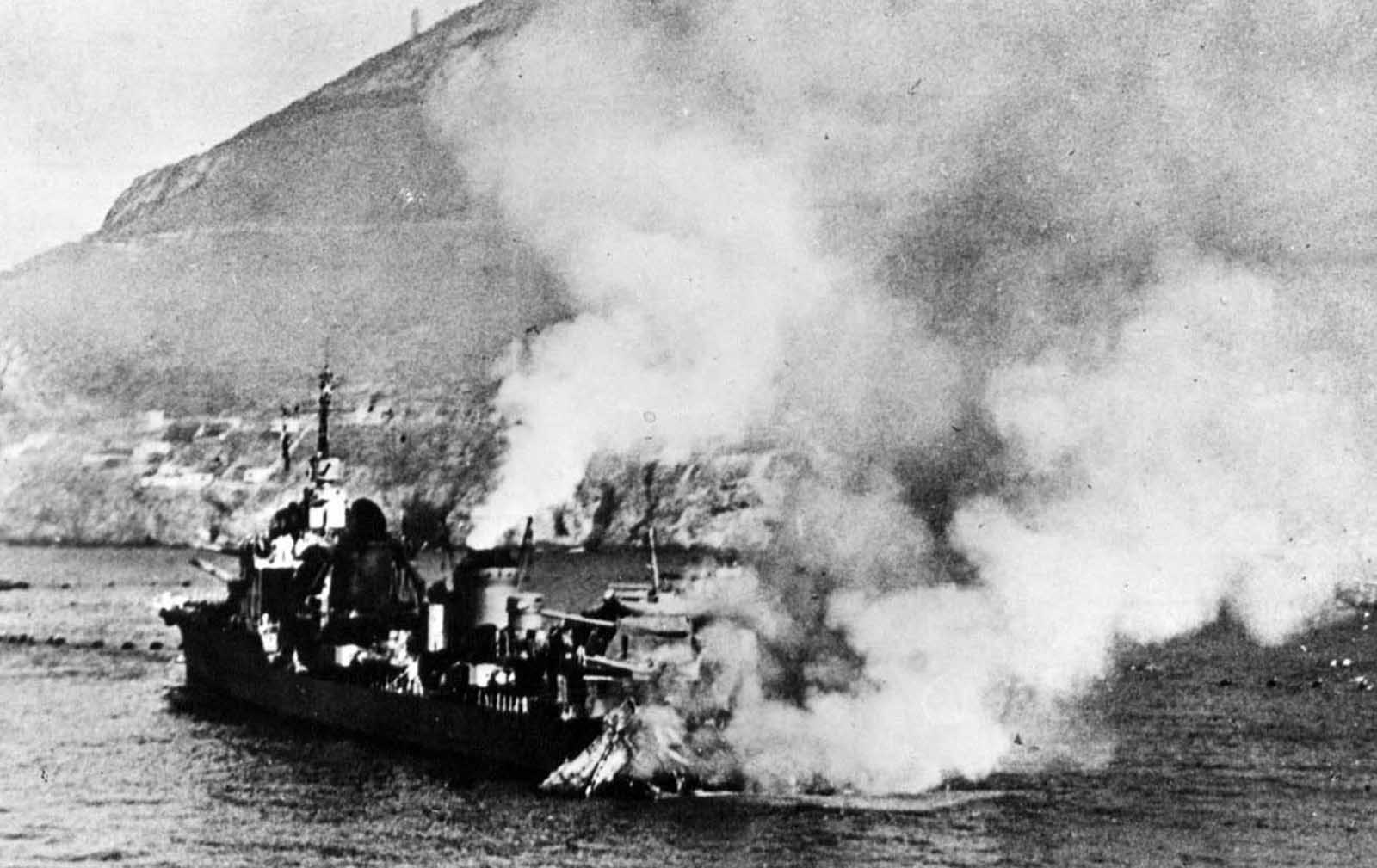 French destroyer Mogador, in flames after being shelled during the British attack on Mers-el-Kebir, French Algeria, on July 3, 1940. After France signed an armistice with Germany, the British government moved to destroy what it could of the French Navy, trying to prevent the ships from falling into German hands. Several ships were badly damaged, one sunk, and 1,297 French sailors were killed in the attack.