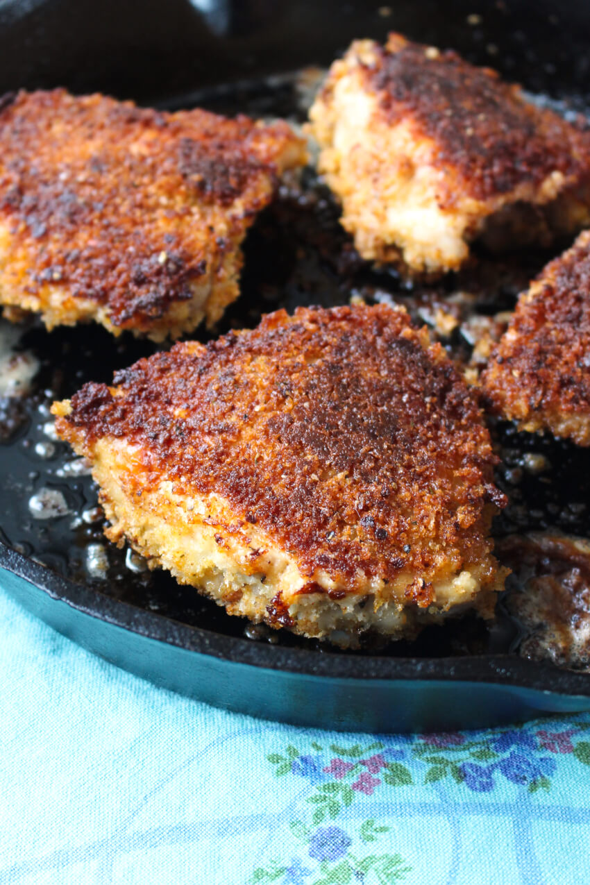 Crispy Oven-Fried Chicken Thighs are baked in a cast iron skillet until the outside is golden and ultra crispy and the inside is juicy and perfectly cooked.  They are the perfect family-friendly weeknight dinner! #chicken #dinner #chickenthighs 