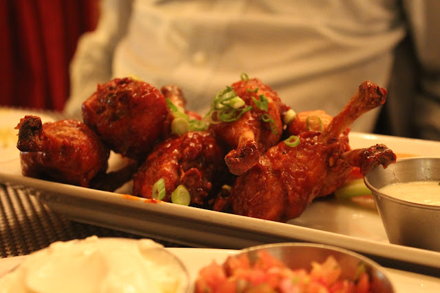 Chipotle honey BBQ chicken lollipops at West on Centre, West Roxbury, Mass.