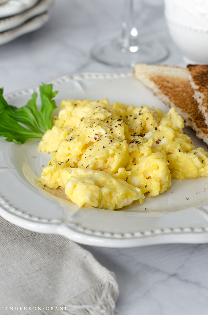 Scrambled eggs and toast on plate