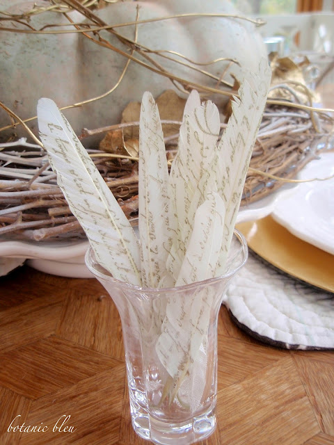 Thanksgiving gold and white table setting with DIY french script stamped white feathers