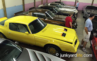 So many treasured Pontiacs under one roof. The silver 10th Anniversary Trans Am gets overlooked next to the Goldenrod Yellow 4-speed Formula.