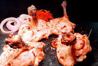 Garnished kalmi kebab with onion slices for chicken kalmi kabab recipe